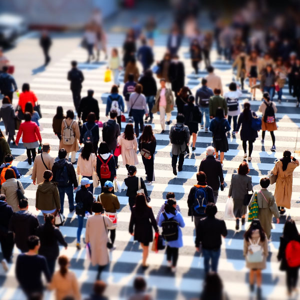 A busy pedestrian crossing with many people crossing